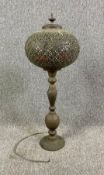 A large North African pierced metal table lamp. H.82cm