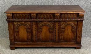 A Titchmarsh and Goodwin 20th century carved oak coffer in the antique style. H.62 W.117 D.49cm