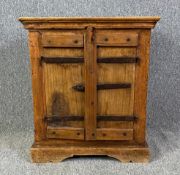 An Eastern teak and metal bound side cabinet. H.60 W.54 D.37cm