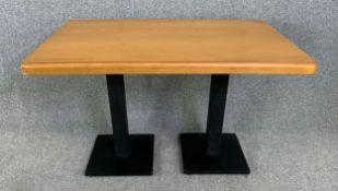 A beech dining table on metal pedestal supports. H.77 W.120 D.75cm