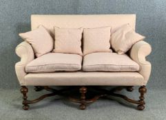 A two seater William and Mary style sofa on walnut turned and stretchered supports. H.105 W.149 D.
