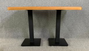 A beech dining table on metal pedestal supports. H.77 W.120 D.75cm