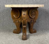 A Regency occasional or lamp table with travertine marble top on carved base with lion's paw feet.