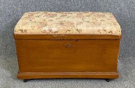 A 19th century painted pine coffer with upholstered top. H.57 W.93 D.49cm
