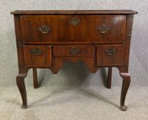 An early Georgian walnut and crossbanded lowboy on cabriole supports. H.92 W.103 D.54cm