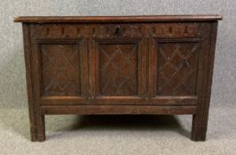 An early 18th century carved oak coffer on stile supports. H.66 W.100 D.55cm
