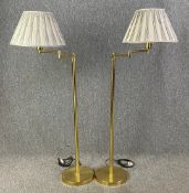 A pair of contemporary Metalarte brass floor standing articulated lamps with shades and maker's