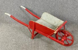 A 19th century painted child's wheelbarrow. L.121cm