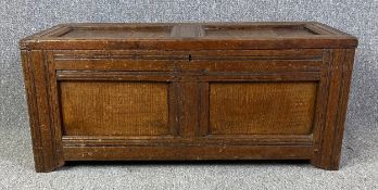 An 18th century oak panelled coffer. H.40 W.93 D.41cm