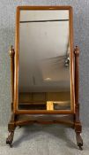A mid 19th century mahogany swing frame cheval dressing mirror. H.150 W.77 D.62cm