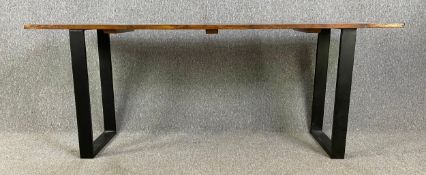 A contemporary stained pine console table on metal trestle supports. H.74 W.195 D.53cm
