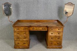 A mid 19th century burr walnut dressing table fitted with a pair of adjustable vanity mirrors. H.