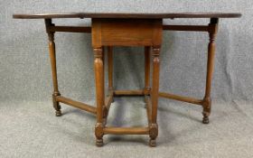An 18th century country elm drop flap dining table with gateleg action. H.75 W.51 (143 extended) D.