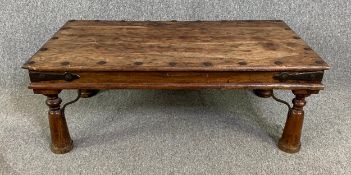 An Indian teak and iron bound coffee table. H.41 W.110 D.60cm