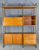 A Staples Ladderax mid-century teak modular wall system with shelves, cabinet, drawers and