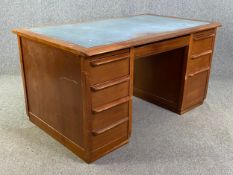 A mid century teak pedestal desk with inset leather top and Angus locking mechanism. H.79 W.153 D.