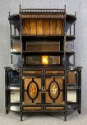 A late 19th century Aesthetic style two section sideboard, ebonised and amboyna with hand painted
