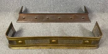 A copper Arts and Crafts fire kerb and a 19th century brass example. H.14 W.120 D.33cm (largest)