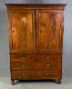 A Regency flame mahogany linen press fitted with slides and hanging rail. H.206 W.146 D.65cm