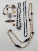 A miscellaneous collection of costume jewellery to include an amethyst bead necklace. L.52cm (