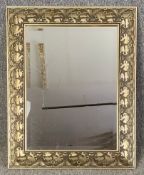 A contemporary gilt framed wall mirror with a bevelled plate. H.79 W.64cm