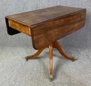 A Regency mahogany drop flap Pembroke table on pedestal base. H.71 W.48 (91 extended) D.91cm