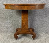 A 19th century continental flame mahogany centre table on pedestal base. H.76 W.87 D.56cm