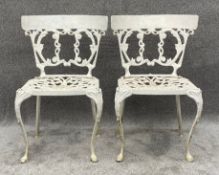 A pair of 19th century style garden or conservatory chairs in cast metal alloy with maker's mark