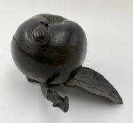 A bronzed iron inkwell in the form of an apple, leaf and stalk. H.10 W.15cm