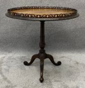 A Georgian carved mahogany tilt top table with pierced galleried top. H.75 Dia.80cm