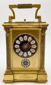 A late 19th century brass repeating carriage clock with alarm function, enamelled dial and