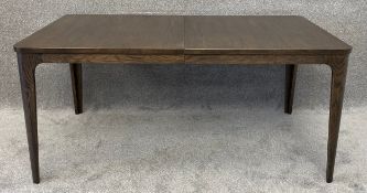 A contemporary oak extending dining table in a vintage style fitted with two integrated leaves. H.74