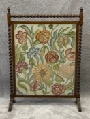 A mid century oak and needlework fire screen, initialled and dated S D 1933. H.103 W.73cm