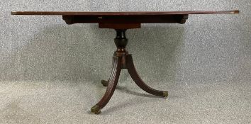 A Regency mahogany dining table with tilt top action. H.72 W.138 D.89cm