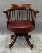 A late 19th century mahogany captain's desk chair in faux leather upholstery with swivel action. H.