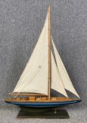 A vintage scratch built pond yacht on stand. H.86 W.61cm
