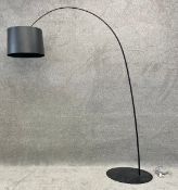 A large contemporary floor standing led arc lamp by Foscarini with a metal base and a black