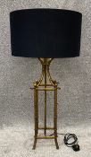A contemporary brass effect metal bamboo style lamp with shade. H.90cm