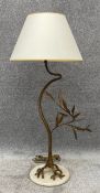 A gilt metal floor standing standard lamp in the form of a stylised branch or tree, on a marble base