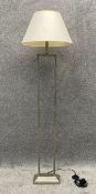 A contemporary stainless steel floor standing lamp with shade. H.153cm