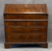 A mid Georgian burr walnut and featherbanded bureau fitted with well and an arrangement of drawers