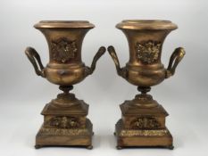 A pair of 19th century gilt metal campana form urns. H.29 W.18cm.