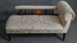 An Edwardian mahogany and satinwood chaise reupholstered in foliate damask. H.69 W.130 D.52cm.