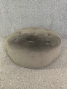 A contemporary footstool in buttoned mink velour. H.40 Dia.103cm