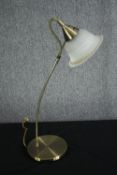 A brass desk lamp with a frosted glass shade. H.62cm.