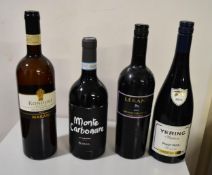 A collection of four bottles of red wine.