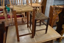 Two vintage stools with woven seats.