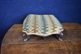 A Victorian footstool on cabriole supports. W.45 D.45