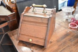 A Victorian oak and brass coal box.