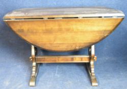 A vintage drop flap dining table. H.76 W.65 extended 125 D.115cm